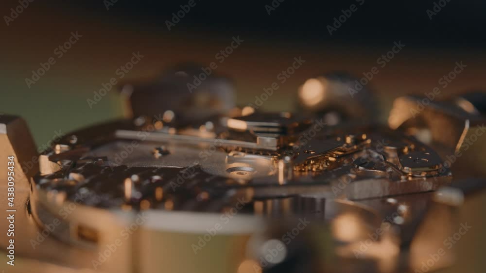 Poster watchmaker screw and assemble mechanical watch in the workshop. - macro