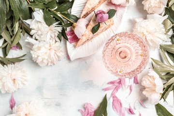Glass Of White Wine, pieces of sweet cake and Peony Flowers. Summer drink for party, wine shop or wine tasting concept