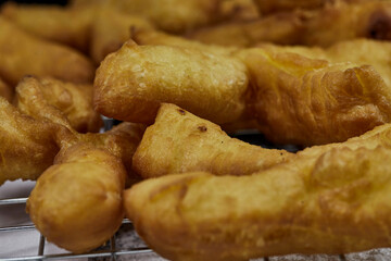 Closeup view of fried dough sticks on cooling rack 
