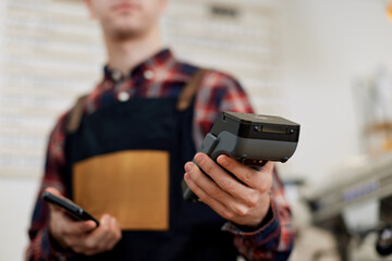 barista in apron hold modern bank payment terminal