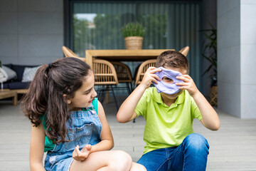 Two kids playing with a slime at home