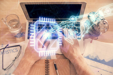 Double exposure of man's hands typing over computer keyboard and data theme hologram drawing. Top view. Technology concept.