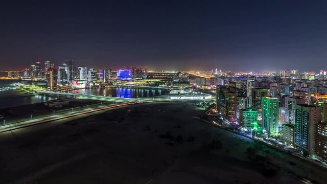 Aerial skyline of Abu Dhabi city centre from above day to night timelapse