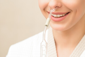 Woman receiving nasal oil inhaler