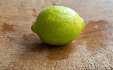 Yellow lemon isolated on a wooden board