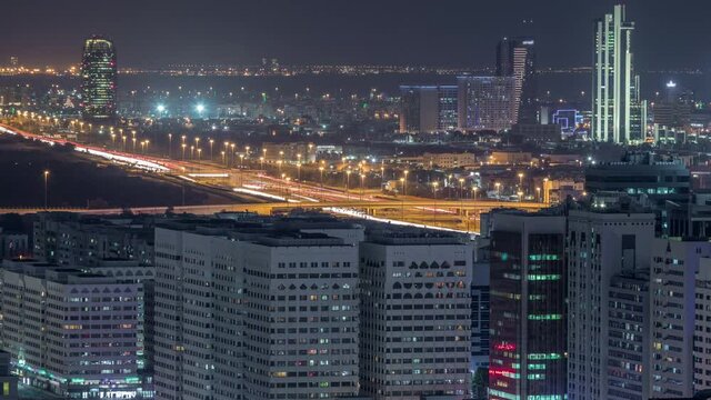 Aerial skyline of Abu Dhabi city centre from above day to night timelapse