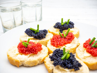 sandwiches with caviar and glasses of vodka aside