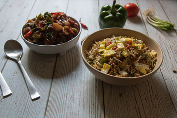 Chinese cuisine fried rice and dry chilli chicken. A popular dish across the globe. Close up.