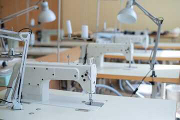Working environment sewing workshop. Tailoring industry. Empty workplaces of seamstresses