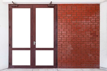 The large entrance door brown solid wood building and the red-brown brick wall