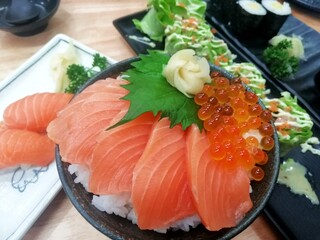 Traditional japanese food including salmon sashimi and fish roe