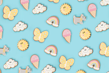 Summer wallpaper, texture made with funny cookie gingerbread on blue background. Top view Flat lay