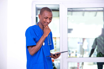 handsome young male doctor working on digital tablet smiling.