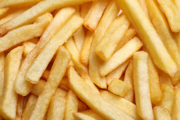 Yummy French fries as background, top view