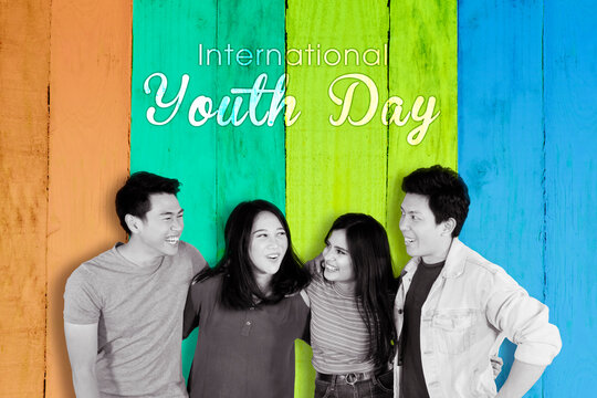 Group Of People With International Youth Day Text