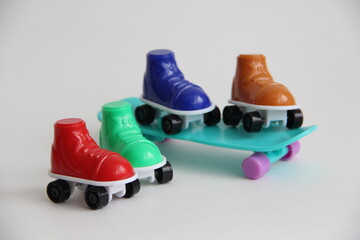 roller skates standing on a skateboard.roller skates of different colors and skate.summer sports skate and roller skates or roller skates on a white background