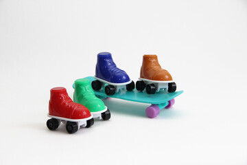 roller skates standing on a skateboard.roller skates of different colors and skate.summer sports skate and roller skates or roller skates on a white background