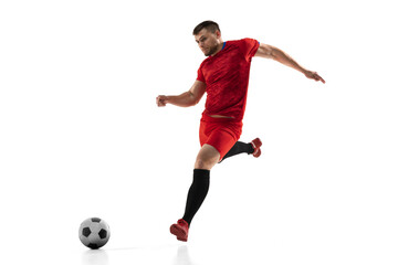 Powerful, flying above the field. Young football, soccer player in action, motion isolated on white background .