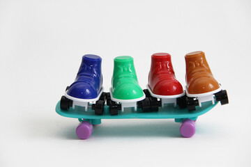 roller skates standing on a skateboard.roller skates of different colors and skate.summer sports skate and roller skates or roller skates on a white background