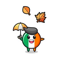 cartoon of the cute ireland flag badge holding an umbrella in autumn