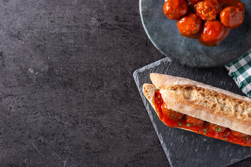 Meatball sub sandwich on black stone. Top view. Copy space