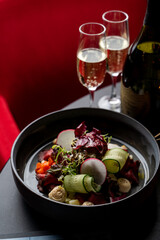 Lamb steak salad on black background in an expensive exclusive restaurant