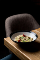 Posh restaurant meal: a portion of creamy italian risotto with pesto sauce, served with a bottle of good sauvignon