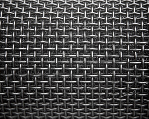 Closeup of a gray metallic microphone grill