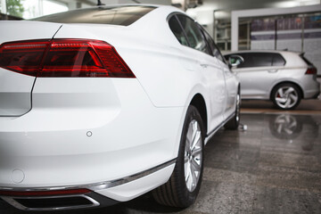 Cropped shot of a new white automobile at car dealership