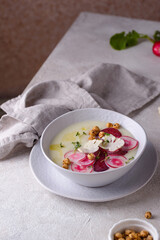 Cauliflower soup puree decorated with radish