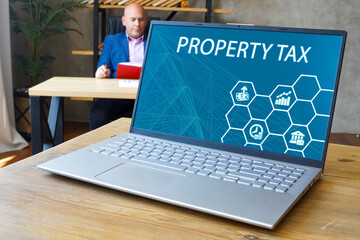 Business concept meaning PROPERTY TAX with inscription on the laptop