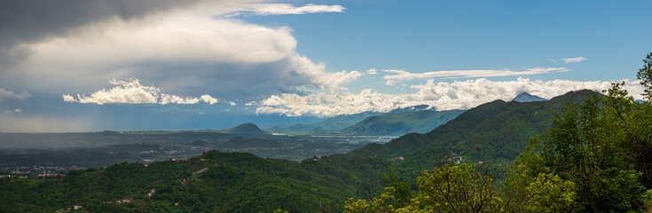 Large panorama view of Friulian Plain and Friulian Dolomites as seen from Julian Prealps, with scenic weather and clouds formations