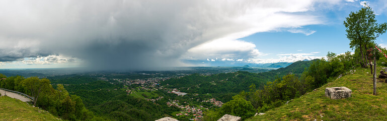 Large panorama view of Friulian Plain from Julian Prealps, with scenic weather and atmospheric disturbance