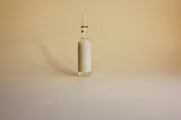 A vial with medicine on a light background. vaccination. The concept of medicine and immunity. Vaccination against viral infections. Flatly. Copy space