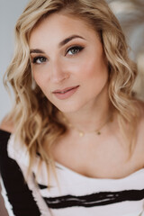 Portrait of a beautiful young blonde woman with clean fair skin. Industry of cosmetology and beauty. Soft selective focus.