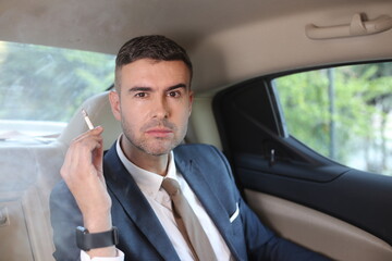 Careless businessman smoking in backseat 