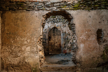 Fototapeta premium Interior of royal palace, Medieval gothic castle Bezdez, grey stone ruin on hill at sunny day, ancient fortress, fairytale stronghold, arched portal, North Bohemia, Czech Republic