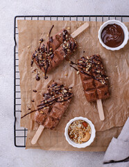 Chocolate ice cream popsicle with nuts
