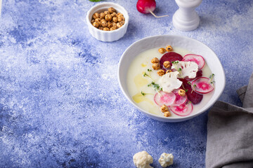 Cauliflower soup puree decorated with radish