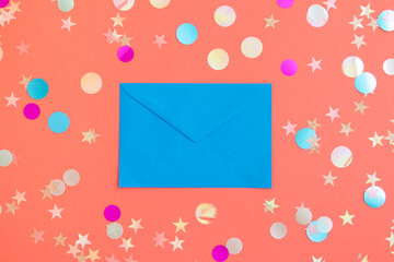 Blue envelope for invitation or correspondence on pink background