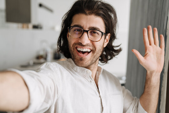 Smiling mid aged turkish brunette man taking selfie