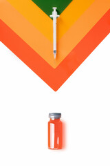 Obraz premium syringe on coloured triangles and vial with liquid on white background. Concept of medicine and coronavirus.