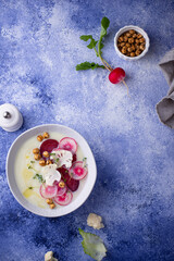 Cauliflower soup puree decorated with radish