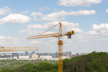 Fototapeta na wymiar Construction cranes at the building of the residential houses