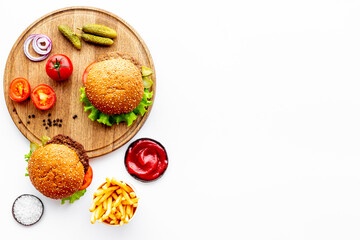 Hamburgers with vegetales and french fries. Top view