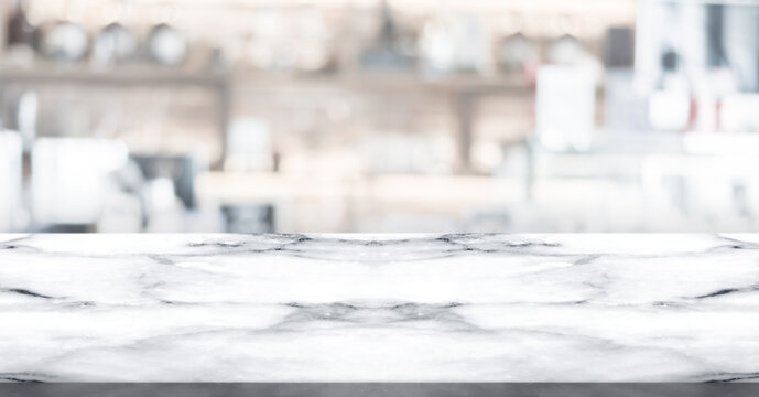 Empty white marble stone table top and blur interior cafe and restaurant.