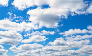 Naklejka na ściany i meble Clear blue sky background. White clouds on the sky