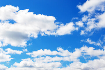 Naklejka na ściany i meble Beautiful blue sky background. White clouds in the bright sky.