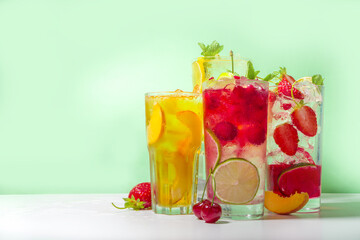 Iced refreshing drink. Bar and caffee beverage menu background. Set of various cold summer cocktails - peach tea, lemonade, mojito, cherry mocktail, with frruits on colorful bright background