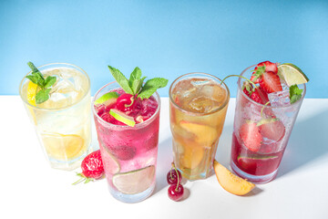 Iced refreshing drink. Bar and caffee beverage menu background. Set of various cold summer cocktails - peach tea, lemonade, mojito, cherry mocktail, with frruits on colorful bright blue background